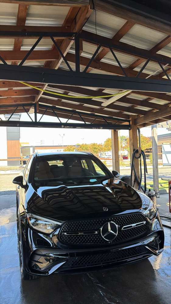 Black Mercedes SUV under the Tee Time Auto Spa carport