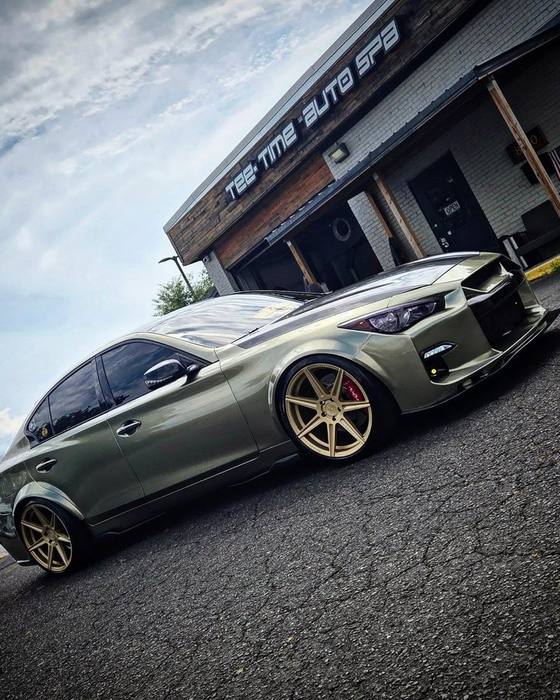 Olive Mazda show sedan at the storefront