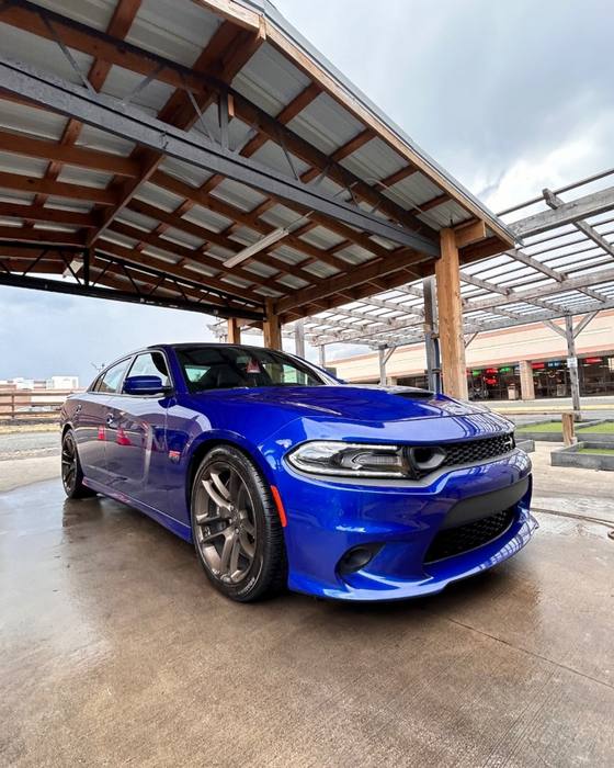Blue Dodge Charger under the carport