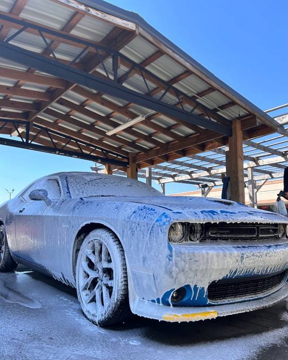 Blue Dodge Challenger covered in foam
