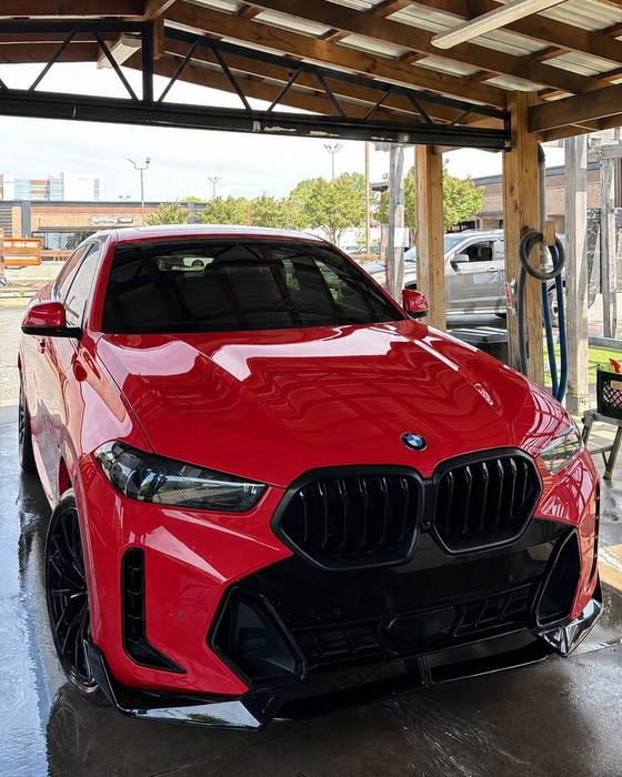 Red BMW X6 under the carport