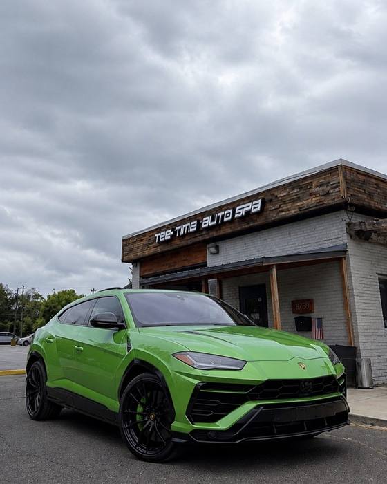 Bright green Lamborghini Urus at the shop